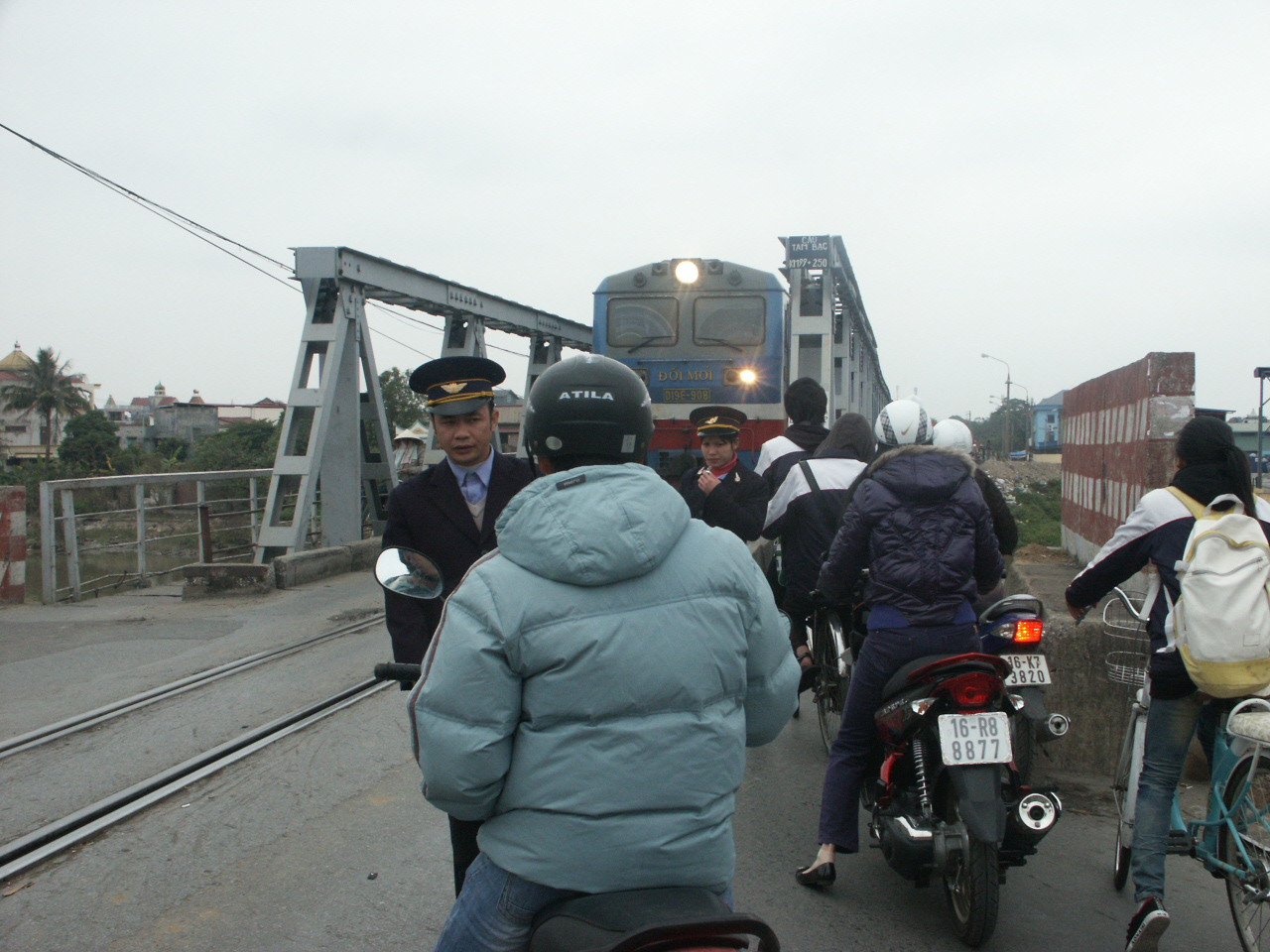 Nhân viên gác tàu ở cầu Tam Bạc cố ngăn cậu thanh niên vượt vì tàu đang đến gần