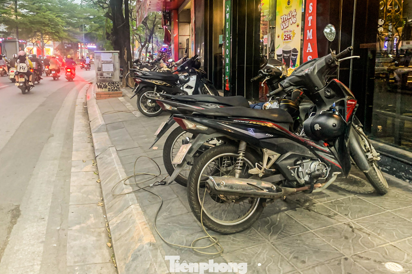 Vỉa hè hẹp thành nơi đỗ xe của các cửa hàng trên đường Nguyễn Khánh Toàn (quận Cầu Giấy).