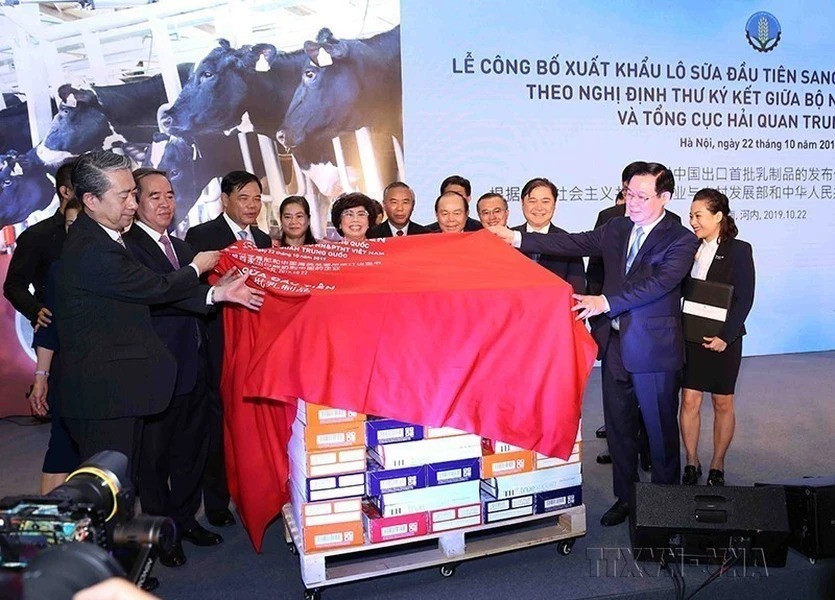 Phó Thủ tướng Vương Đình Huệ, Trưởng ban Kinh tế Trung ương Nguyễn Văn Bình cùng các đại biểu thực hiện nghi lễ xuất khẩu lô sữa đầu tiên giữa Tập đoàn TH và đối tác Trung Quốc (Hà Nội, 22/10/2019). (Ảnh: TTXVN)