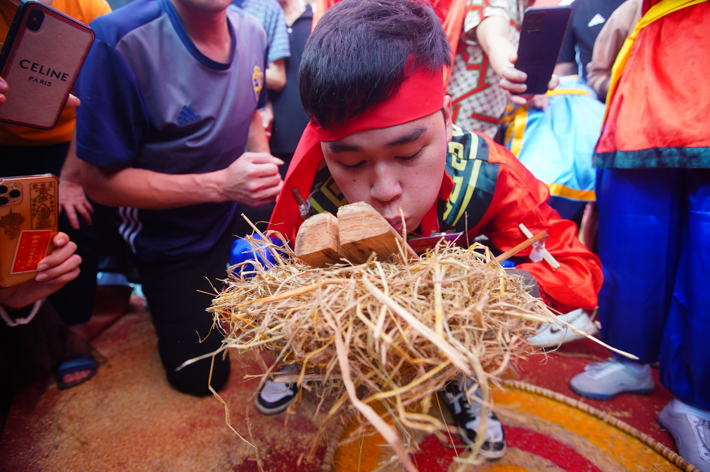 Ma sát đủ nóng để tạo ra than trên thân tre, bén với bùi nhùi khô gây cháy. Người trưởng nhóm cầm bó rơm lên thổi mạnh để lửa bốc cháy to hơn.