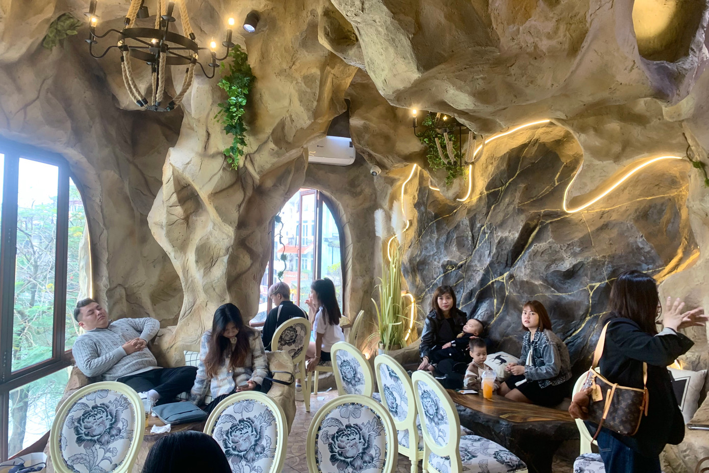 Quán cafe bên hồ Tây lạ mắt với kiến trúc lạ, như một hang động thu nhỏ, một góc thiên nhiên giữa lòng phố thị. Bên trong quán là những khối đá nhân tạo, thiết kế gồ ghề xếp chồng lên nhau, tạo ra một không gian thiên nhiên, xanh mát.