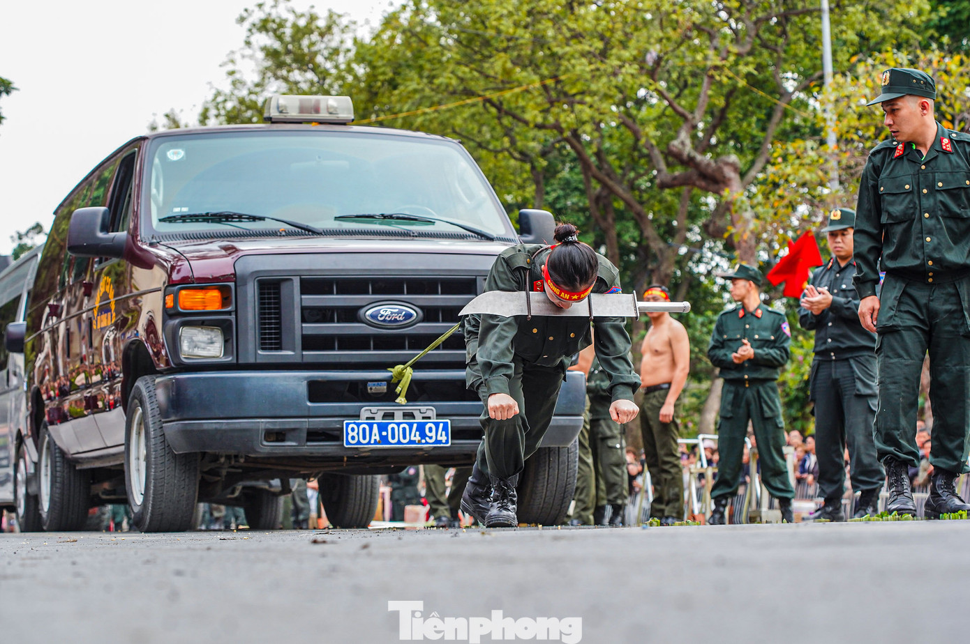 Nữ cán bộ Cảnh sát cơ động kéo xe ô tô chống đạn bằng thanh sắt vòng qua cổ với dao sắc.