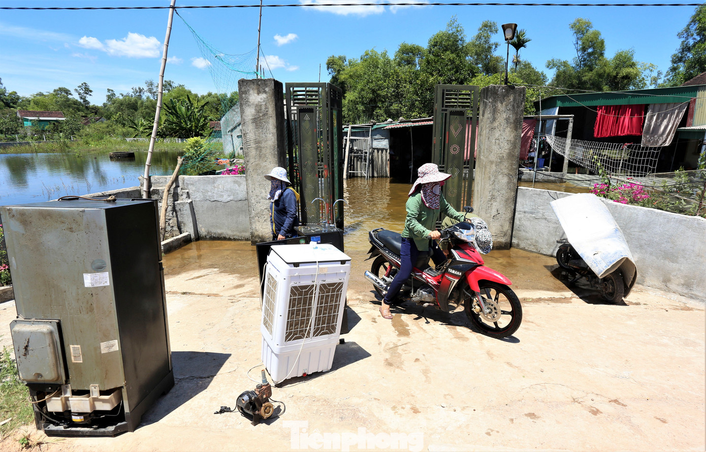 Một số thiết bị điện như quạt, máy bơm, tủ lạnh... bị ngập nước được người dân đưa ra nắng phơi và thuê người sửa lại.