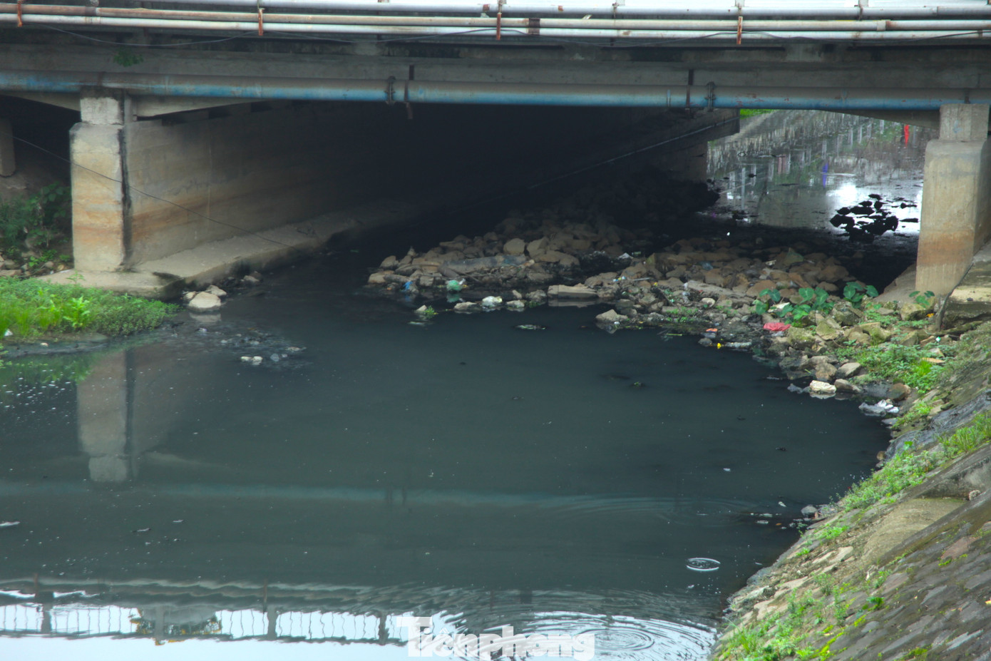 Dưới cầu đường 3/2, lượng lớn đá, rác đã chắn ngang dòng chảy kênh khiến tình trạng nước đọng và gây mùi hôi thối.