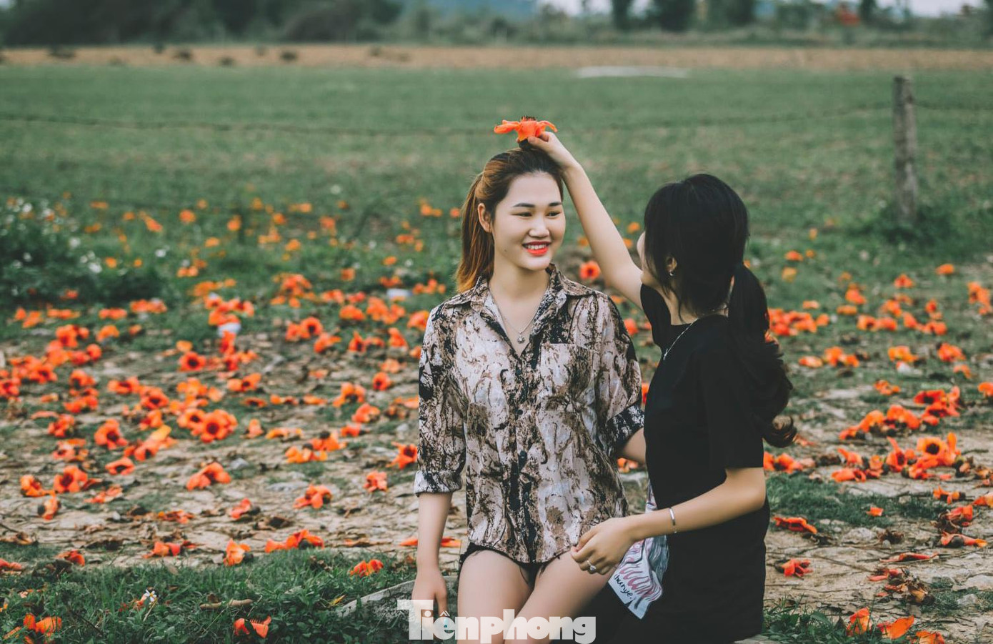 Gốc hoa gạo rực đỏ trở thành nơi lý tưởng để lưu giữ khoảnh khắc của đôi bạn thân.