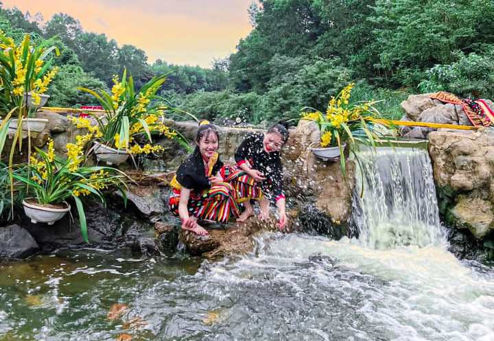 Thiếu nữ Thái hòa mình trong dòng suối cá hiền hòa, mát lành.