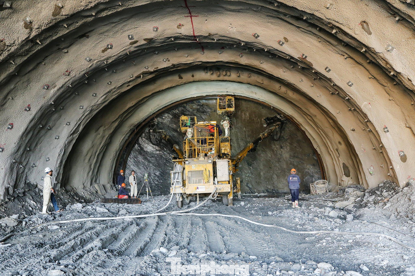 Tại công trường phía Nam hầm Trường Vinh, hàng chục công nhân và xe máy cả bên ngoài lẫn trong hầm miệt mài làm việc.