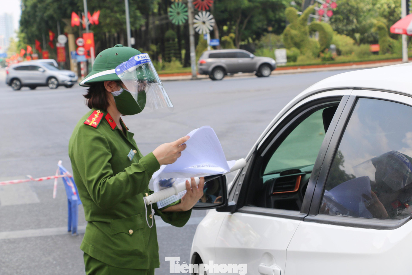 Người tham gia giao thông phải xuất trình các giấy tờ đã được quy định. Trong ảnh: Đại úy Nguyễn Thị Thu Hường (Phòng PC06), thực hiện nhiệm vụ tại chốt T32 ngã tư Quảng trường Hồ Chí Minh. Chị Hường cho hay, chồng chị cũng là công an nên vắng nhà, các con phải gửi ông bà nội ở quê chăm sóc.