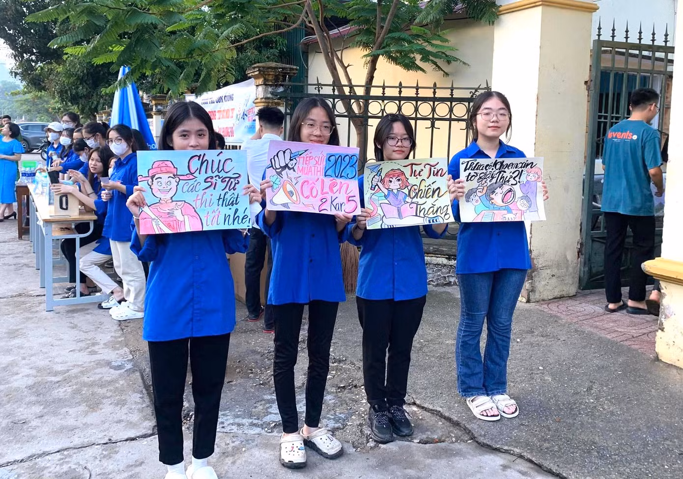 Những bóng hồng đứng trước cổng các điểm thi giơ cao những bức tranh cổ vũ cho các thí sinh tự tin làm bài.
