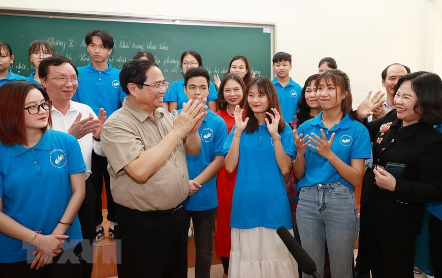 Thủ tướng Phạm Minh Chính thăm học sinh, sinh viên khuyết tật tại Trung tâm hỗ trợ phát triển giáo dục hòa nhập thuộc Trường Cao đẳng Sư phạm Trung ương. (Ảnh: Dương Giang/TTXVN)