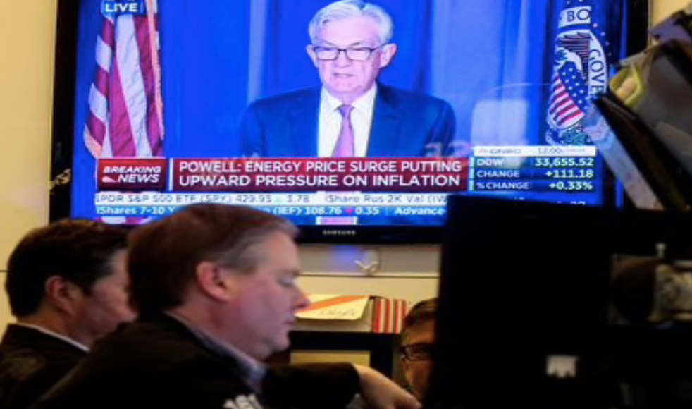Hình ảnh chủ tịch Fed Jerome Powell phát biểu xuất hiện trên màn hình tại sàn chứng khoán New York ngày 16/3. (Ảnh: Reuters)