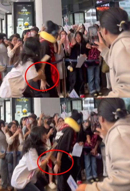 Rhyder bị fan kéo tay khá mạnh, có thể khiến anh bị đau. Ảnh: Cắt từ video của @hatrangoi.