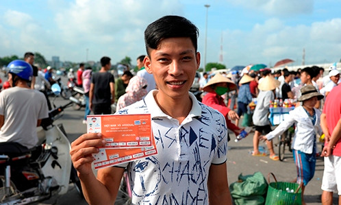 Anh Đào Kim Tuấn đang khoe cặp vé mà anh đã phải xếp hàng rất vất vả từ 5 giờ sáng mới có thể mua được