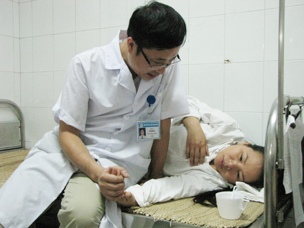 Sức khoẻ yếu, lại bị chen lấn giữa đám đông, chị phải nhờ đến sự trợ sức, cấp cứu của bệnh viện. Ảnh: Lãng Phong