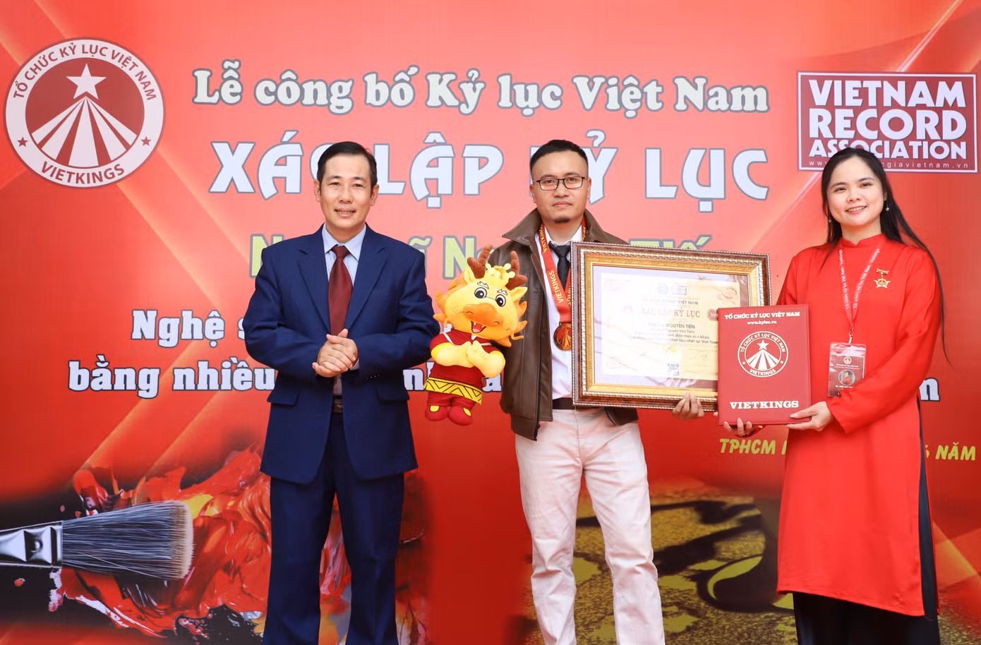 Ông Dương Duy Lâm Viên (trái), Tổng Thư ký Trung ương Hội Kỷ lục gia Việt Nam, Viện trưởng Viện Kỷ lục gia Việt Nam trao bằng công nhận cho nghệ sĩ Nguyễn Tiến. Ảnh: Ngô Tùng.