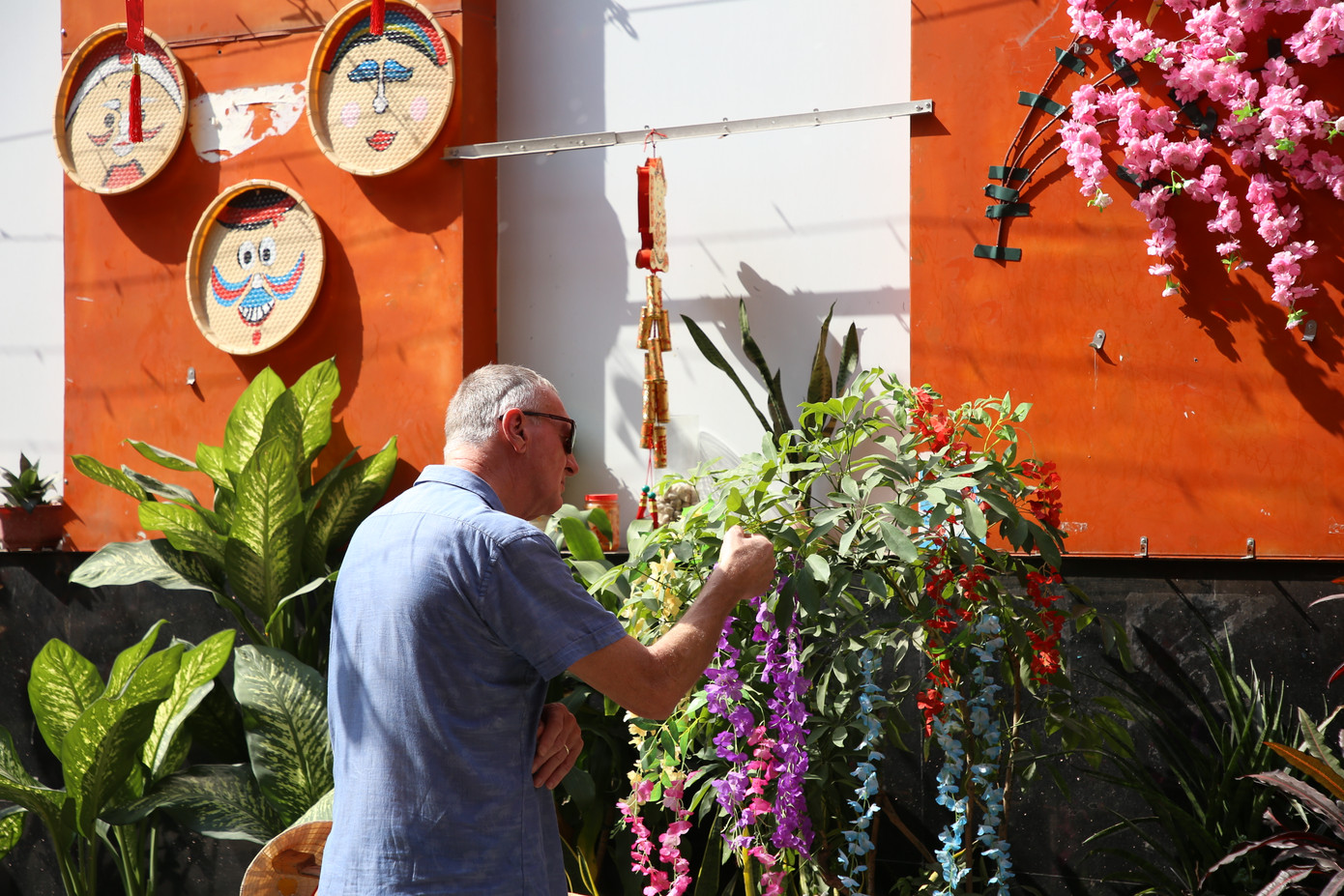 Một du khách nước ngoài thích thú đến gần để ngắm nhìn những vật phẩm được trưng bày.