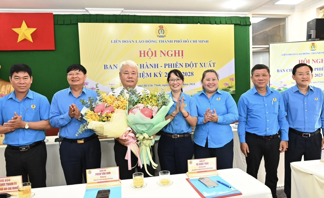 Bà Trần Thị Diệu Thúy (thứ 4 từ phải qua) - Phó Chủ tịch UBND TPHCM, nguyên Chủ tịch LĐLĐ TPHCM cùng các đại biểu tặng hoa chúc mừng ông Võ Khắc Thái. Ảnh: SGGP