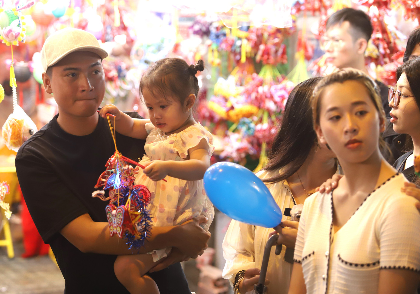 Em bé với chiếc lồng đèn rực rỡ sắc màu trên tay.