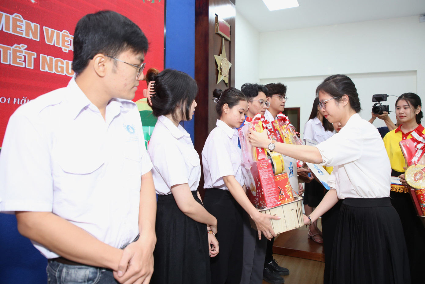 Chị Nguyễn Thị Ngọc Anh - Phó Giám đốc Trung tâm Hỗ trợ và Phát triển sinh viên Việt Nam trao quà Tết tới các bạn cán bộ Hội.