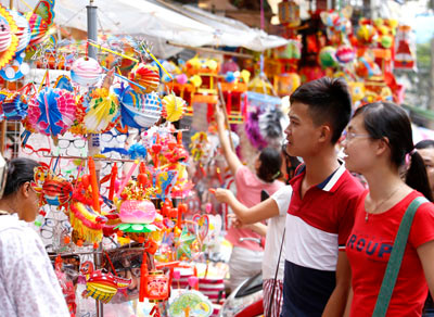 Đôi thanh niên đang chọn đèn lồng chạy bằng pin. Đôi thanh niên đang chọn đèn lồng chạy bằng pin