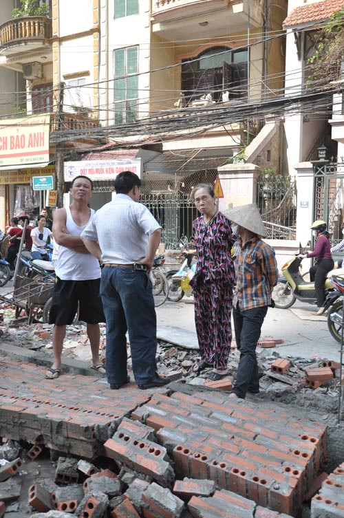 Người dân đứng chờ chủ đơn vị thi công để phản ánh về việc thi công vi phạm khoảng đất lưu không