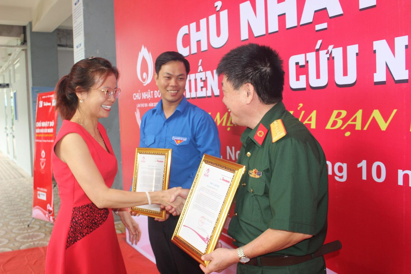 Chị Đặng Thụy Đông Nghi (Phó phòng Kinh doanh báo Tiền Phong) trao thư cảm ơn cho Bệnh viện Quân Y 175 và Trường ĐH Công nghệ Thông tin (ĐHQG TPHCM) - hai đơn vị phối hợp đồng tổ chức chương trình.