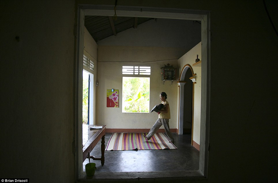 Một người mẹ ở nhà chăm sóc con đang bị ảnh hưởng bởi chất độc da cam ở Huyện Quảng Ninh