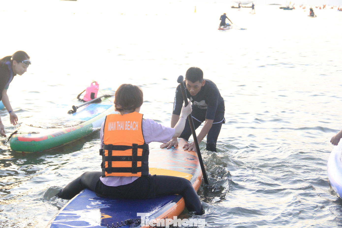 Huấn luyện viên hướng dẫn người chơi cách giữ thăng bằng khi ngồi trên thuyền.