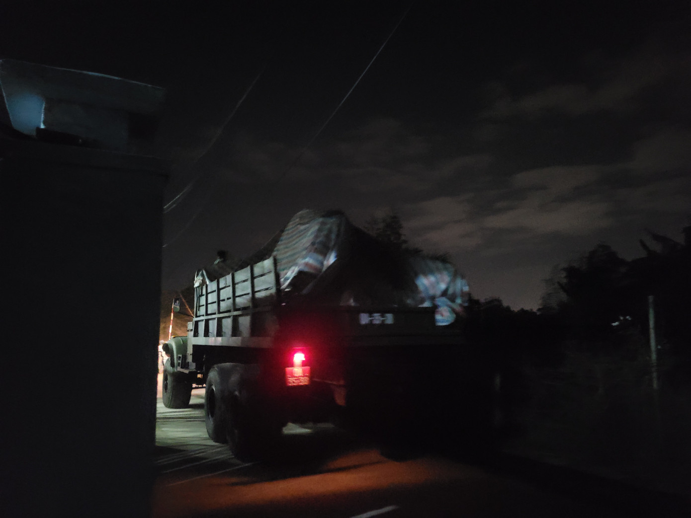 Xe quân đội liên tục chở các thiết bị, mảnh vỡ từ máy bay ra khỏi khu dân cư trong đêm. (Ảnh: Giang Thanh).