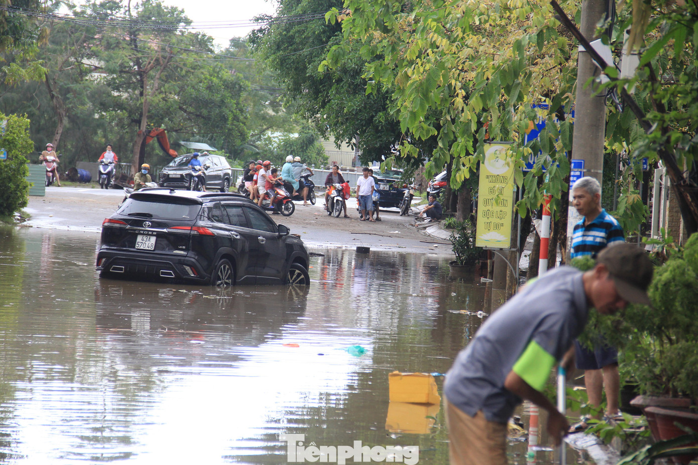 Một xe ô tô bị nước nhấn chìm, đến sáng nay vẫn chưa được di chuyển ra khỏi đoạn đường ngập.