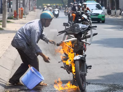 Anh Hiệp dập lửa cứu xe. Ảnh: Duy Khương