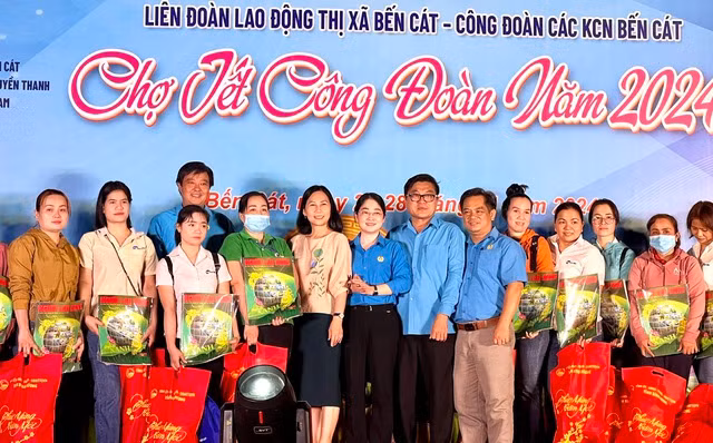 Hiện tại, Bến Cát có 8 khu công nghiệp và 1 khu sản xuất tập trung, giải quyết việc làm cho khoảng 180.000 lao động; có 5.985 dự án đầu tư, trong đó, có 5.186 dự án trong nước với tổng số vốn gần 55 tỉ đồng và 799 dự án nước ngoài với tổng vốn 9,28 tỉ USD (Trong ảnh: Các cấp Công đoàn và chính quyền địa phương tặng quà cho công nhân dịp Tết nguyên đán 2024)