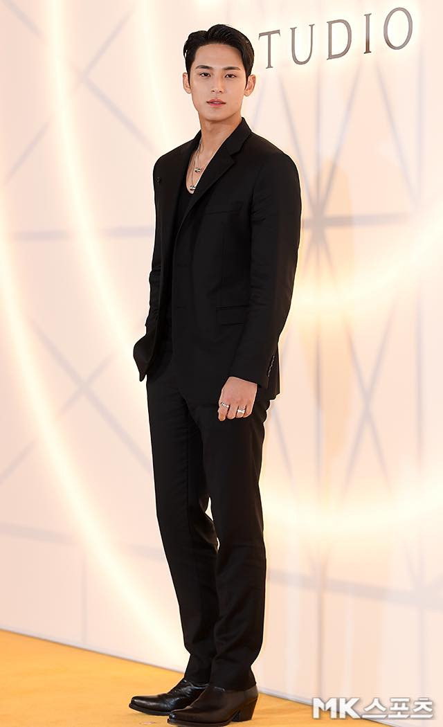 Mingyu (Seventeen) bảnh bao khi diện bộ vest đen đơn giản, áo ba lỗ đen và phụ kiện bạc.