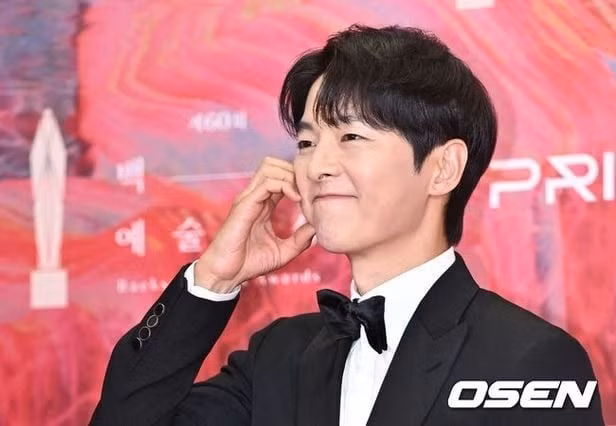 Song Joong Ki tạo dáng trái tim khi đi thảm đỏ Baeksang 2024. Ảnh: Osen. Song Joong Ki tạo dáng trái tim khi đi thảm đỏ Baeksang 2024. Ảnh: Osen.