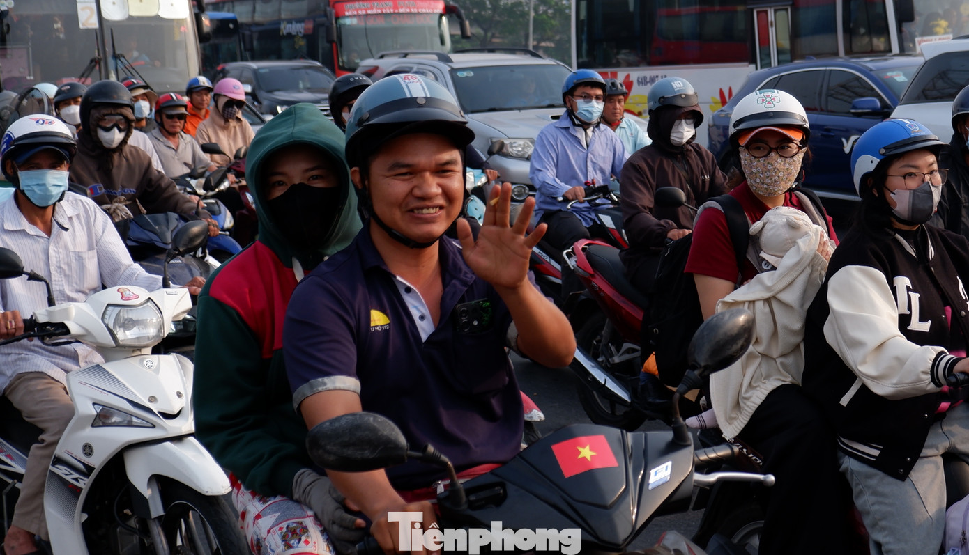 Người dân lỉnh kỉnh đồ đạc, rời TPHCM trên xe máy để về quê nghỉ Tết.