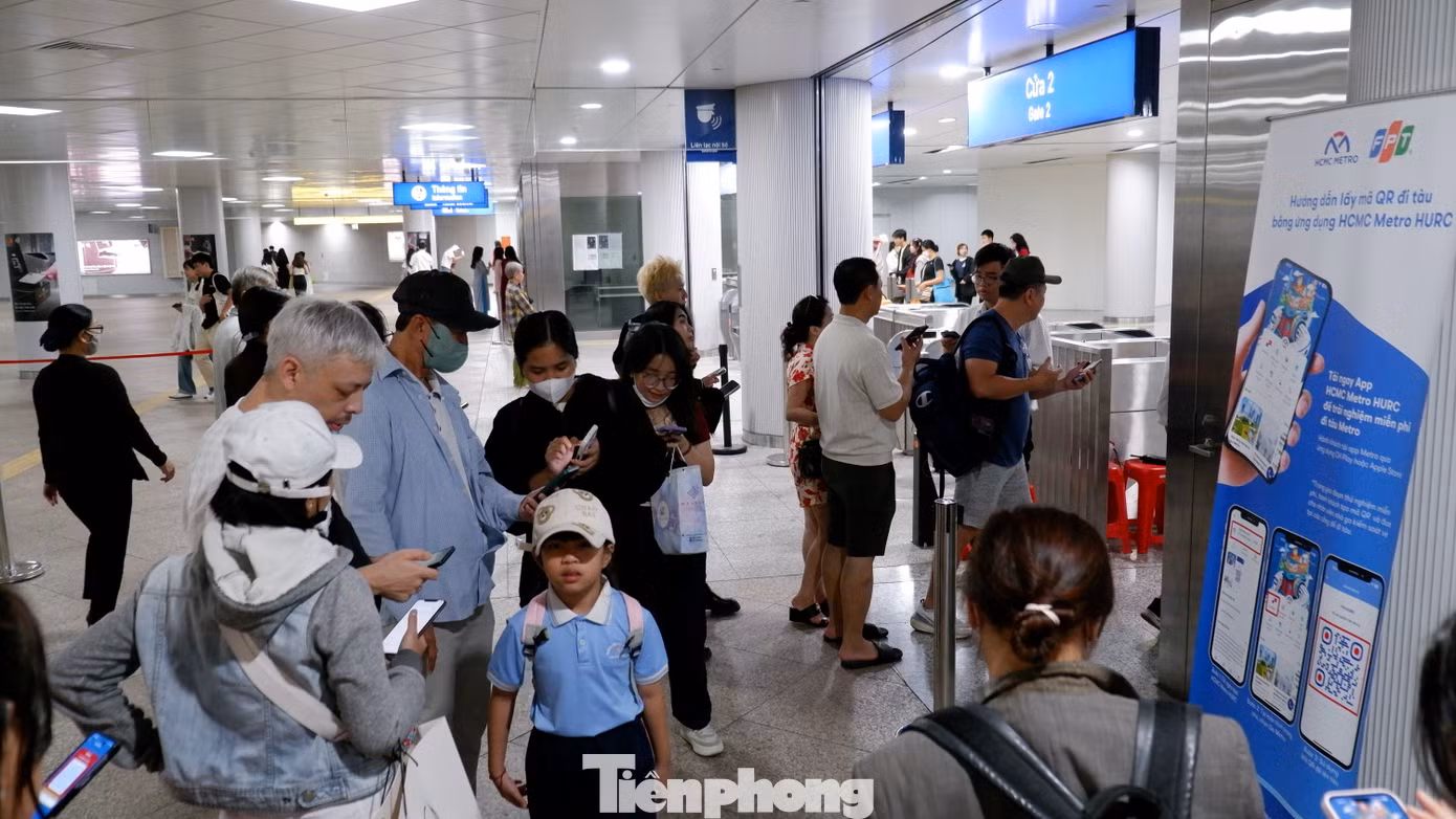 Hành khách tải ứng dụng HCM METRO để đi tàu tại nhà ga Bến Thành, quận 1.