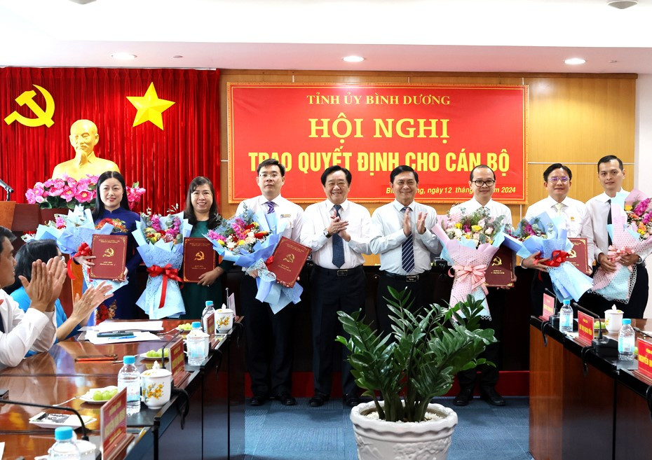 Ông Nguyễn Hoàng Thao, Phó Bí thư Thường trực Tỉnh ủy Bình Dương (thứ tư từ trái sang) và ông Nguyễn Văn Lộc, Chủ tịch HĐND tỉnh Bình Dương (thứ tư từ phải sang) chúc mừng các cán bộ được điều động, bổ nhiệm. Ảnh: Phương Chi