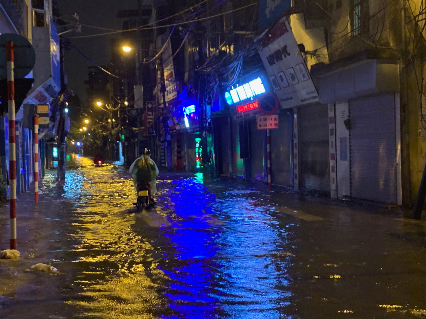 Gắng gượng vượt qua con phố Lương Thế Vinh (quận Thanh Xuân) mênh mông nước tối 7/9. Ảnh: Thái An.