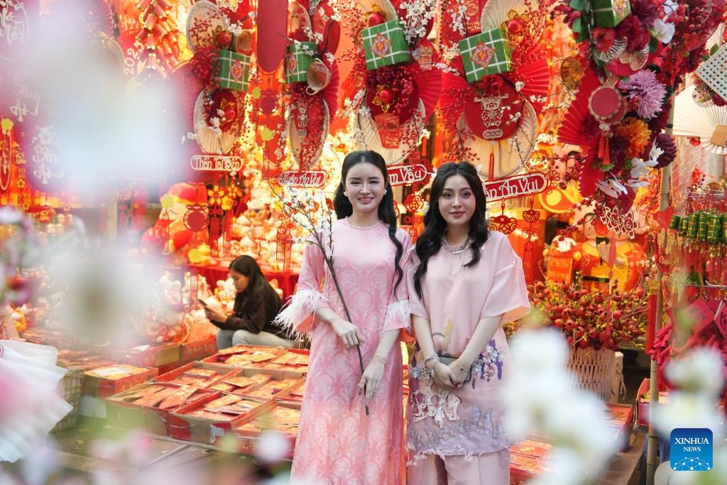 Giới trẻ Việt Nam mặc áo dài chụp ảnh Tết. (Ảnh: Tân Hoa Xã) Giới trẻ Việt Nam mặc áo dài chụp ảnh Tết. (Ảnh: Tân Hoa Xã)