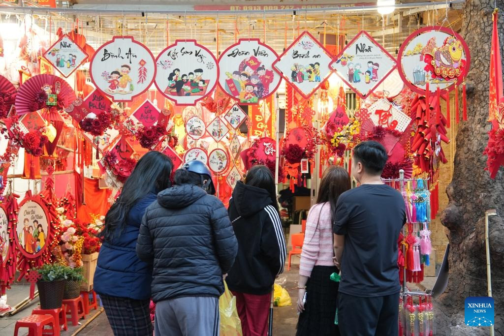 Hình ảnh người dân Việt Nam sắm Tết được Tân Hoa Xã đăng tải. (Ảnh: Tân Hoa Xã) Hình ảnh người dân Việt Nam sắm Tết được Tân Hoa Xã đăng tải. (Ảnh: Tân Hoa Xã)