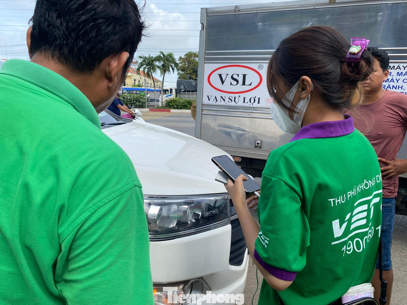 Nhân viên hỗ trợ dán thẻ ETC cho tài xế ở trạm thu phí An Sương - An Lạc. Nhân viên hỗ trợ dán thẻ ETC cho tài xế ở trạm thu phí An Sương - An Lạc.