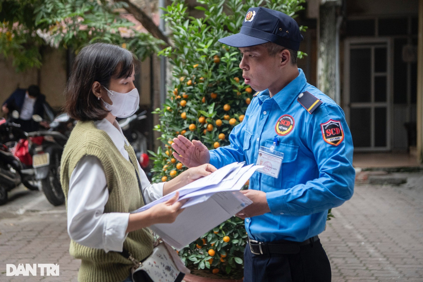 Để người dân xếp hàng trật tự, an toàn, anh Vũ Thái Hiên, nhân viên bảo vệ, phải liên tục nhắc nhở, hướng dẫn mọi người xếp hàng theo thứ tự, chuẩn bị sẵn hồ sơ cầm trên tay.