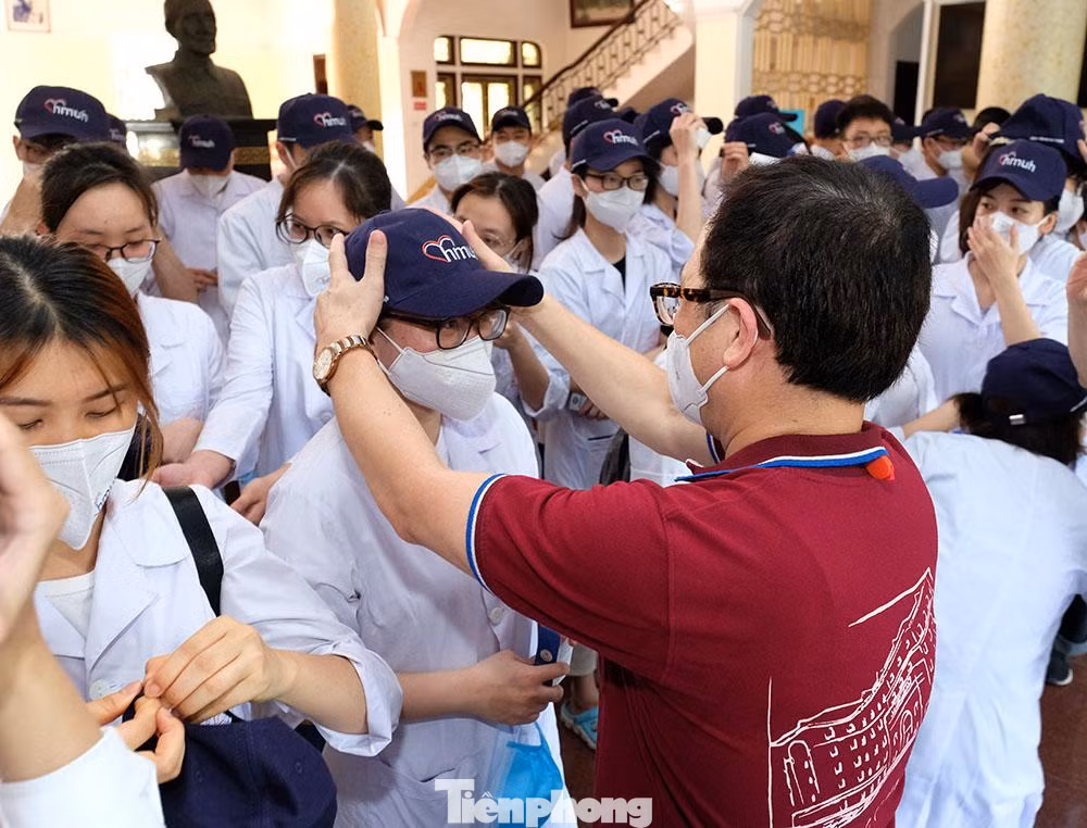Phát biểu tại Lễ ra quân đợt 2, GS.TS Tạ Thành Văn - Chủ tịch Hội đồng trường cho biết: "Trong đợt ra quân trước, 40 cán bộ và sinh viên Nhà trường tình nguyện chi viện cho Bắc Ninh được đánh giá rất cao trong việc phối hợp với nhân viên y tế địa phương trong công tác phòng chống dịch. Nhà trường hy vọng cán bộ và các em sinh viên tiếp tục sẽ nỗ lực hết mình, góp một phần sức lực nhỏ bé của mình trong cuộc chiến chống dịch của cả nước". Trong ảnh, GS Văn đang đội mũ cho những sinh viên tình nguyện lên đường chống dịch COVID-19.