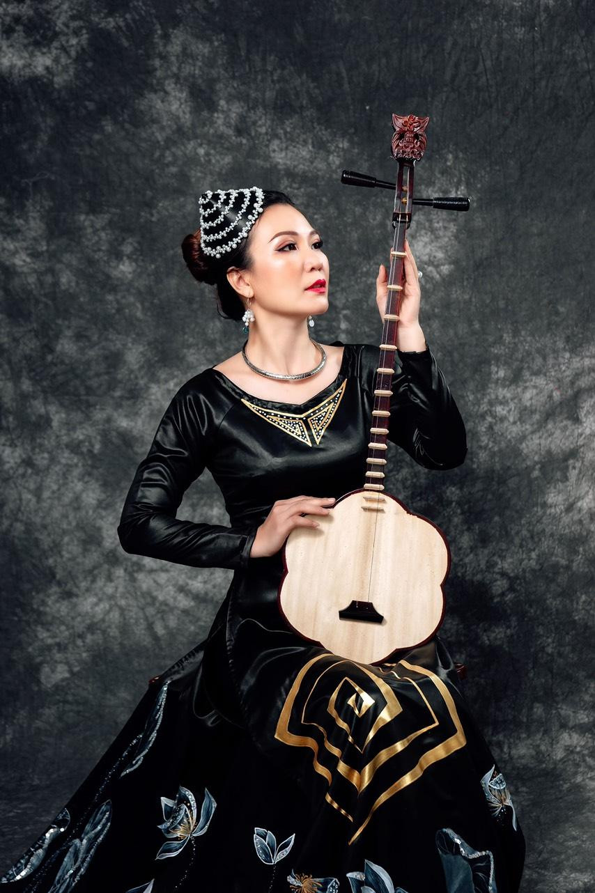 Nhà thơ Huệ Thi khoác trên mình chiếc áo dài trong bộ sưu tập đờn ca tài tử do chính chị thiết kế