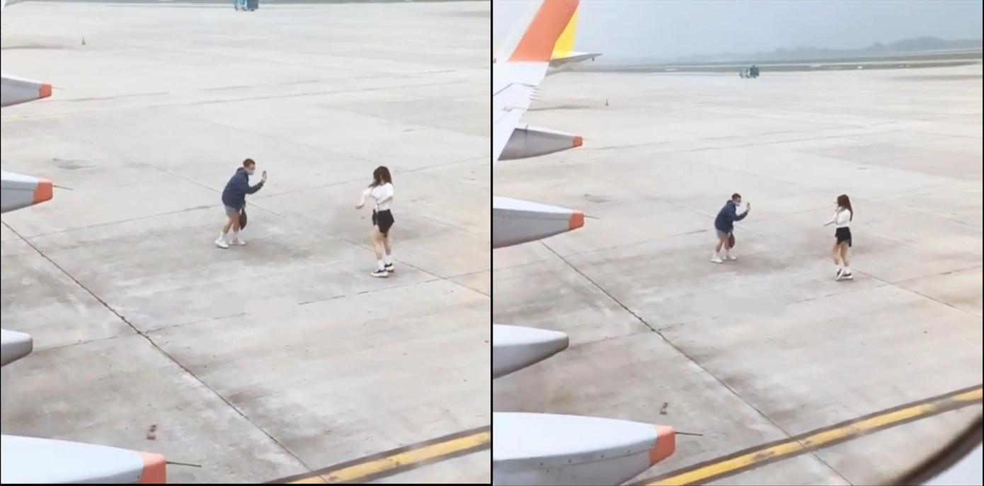 Hai hành khách cố nán lại sân bay nhún nhảy để quay clip được một hành khách khác đã ngồi trên máy bay quay lại và chia sẻ lên mạng xã hội. Ảnh cắt từ clip Hai hành khách cố nán lại sân bay nhún nhảy để quay clip được một hành khách khác đã ngồi trên máy bay quay lại và chia sẻ lên mạng xã hội. Ảnh cắt từ clip