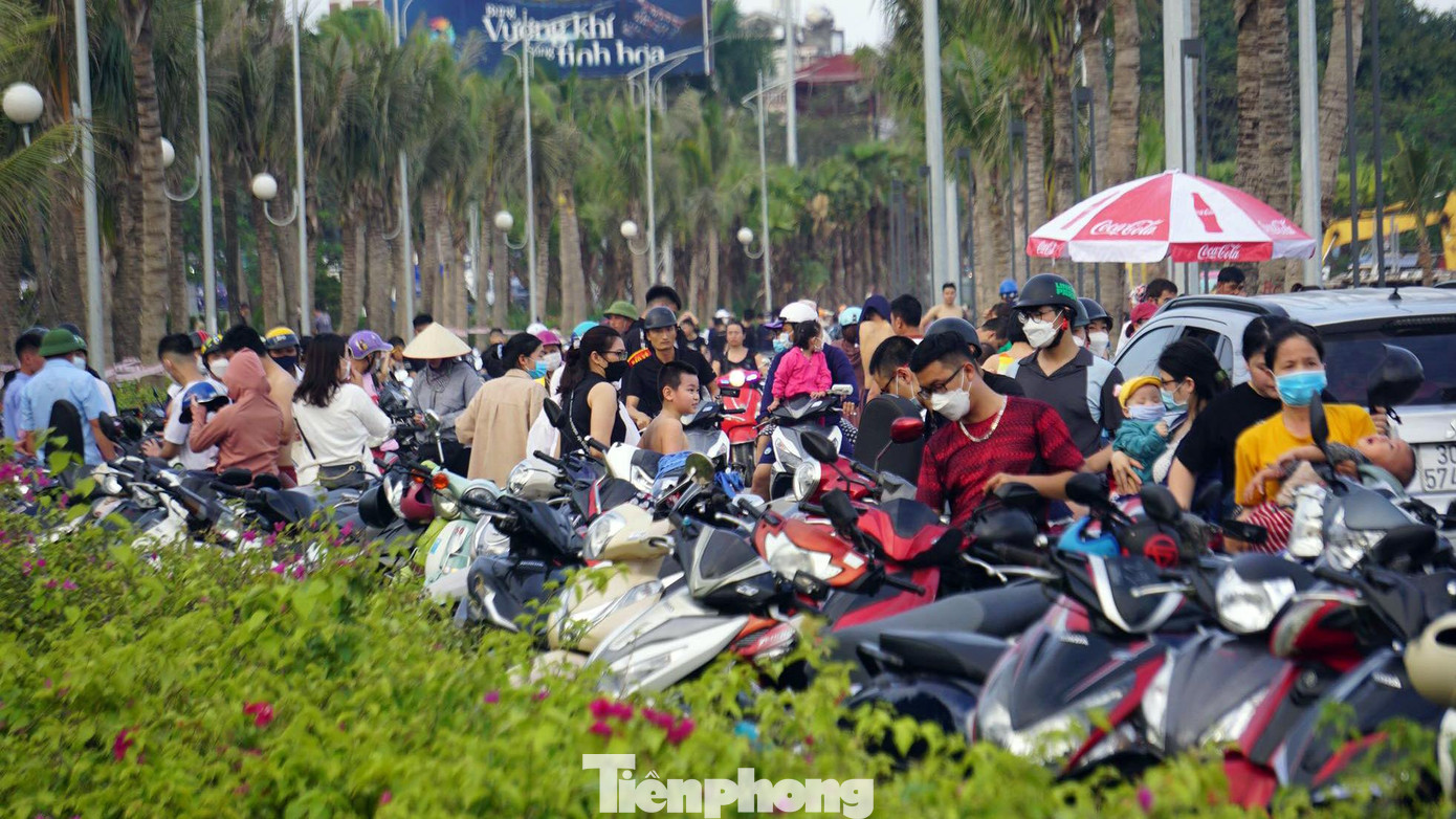 Phía ngoài, hành lang dọc bãi tắm công cộng chật kín chỗ để xe máy.