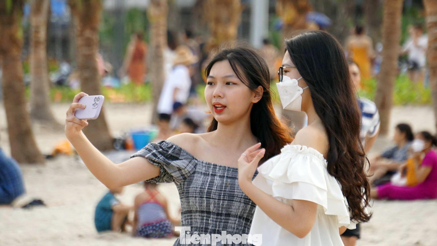Nhiều bạn trẻ thích thú chụp ảnh check-in trên bờ cát trắng.