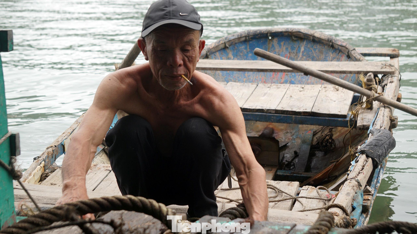 Nhân viên một nhà hàng sửa dây neo hư hỏng tại khu mới đối diện Bến Bèo do sóng to gió lớn.
