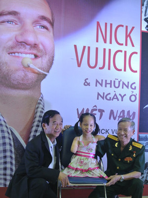 Bé Linh Chi chụp ảnh lưu niệm cùng GS Nguyễn Lân Dũng và một thương binh mất cánh tay. Ảnh: VOV