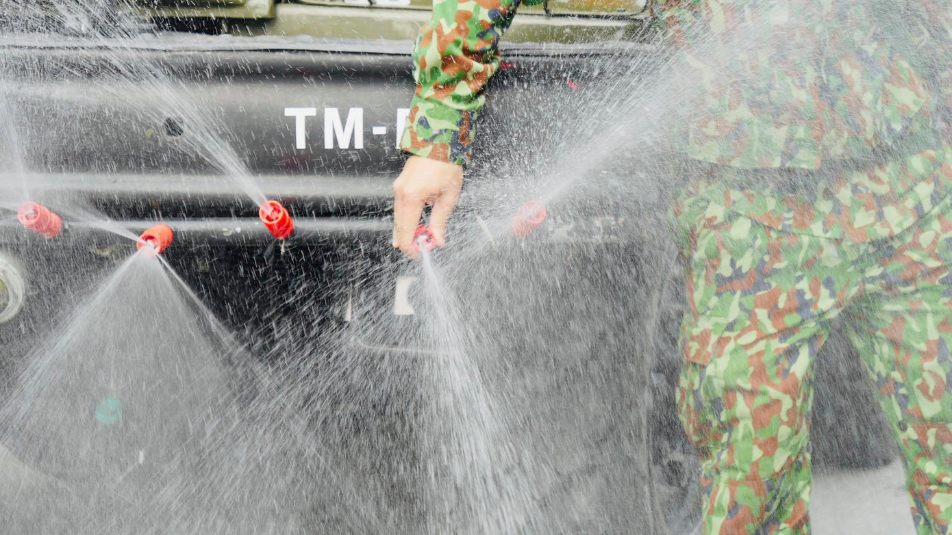 Các xe đặc chủng nối đuôi nhau phun khử khuẩn một cách kỹ lưỡng.